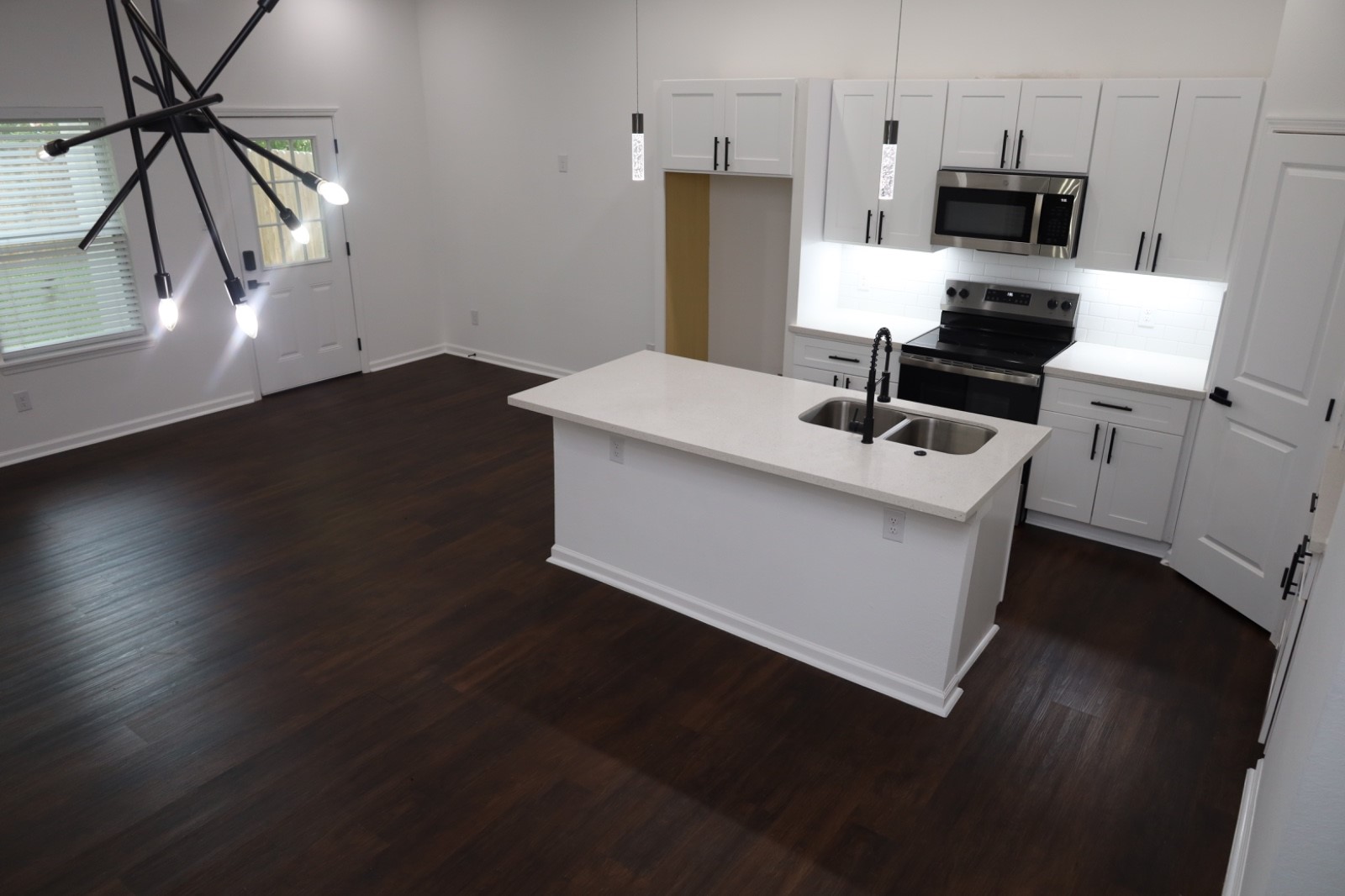 6614 Foster Street Houston, TX 77021 - Photo 3 of 15 a kitchen with stainless steel appliances a microwave a stove and white cabinets
