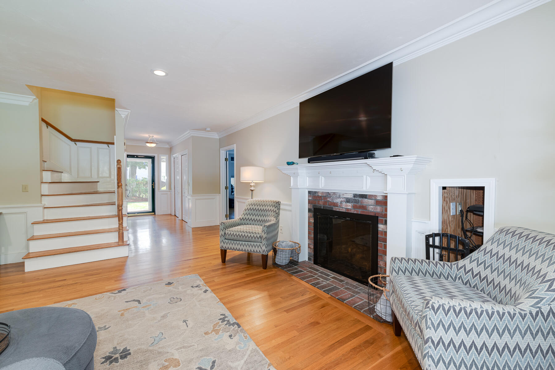 37 Whitmar Road Cotuit, MA 02635 - Photo 12 of 83 a living room with furniture a flat screen tv and a fireplace