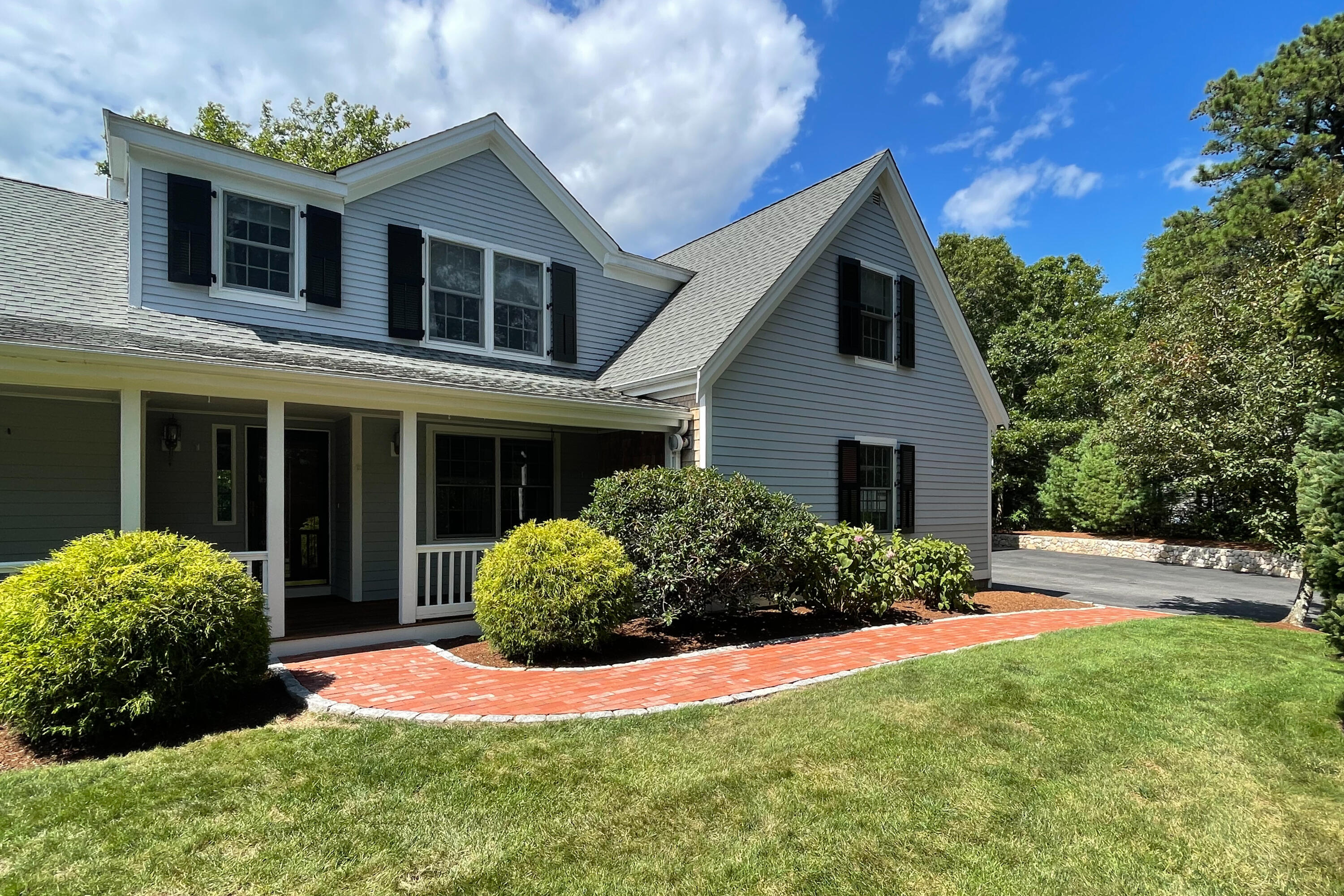 37 Whitmar Road Cotuit, MA 02635 - Photo 4 of 83 a front view of a house with a yard and garage