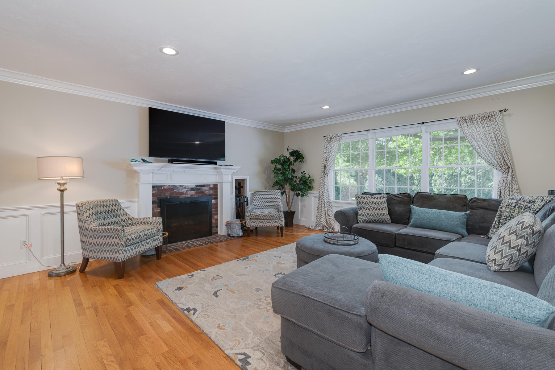 37 Whitmar Road Cotuit, MA 02635 - Photo 10 of 83 a living room with furniture a fireplace and a flat screen tv
