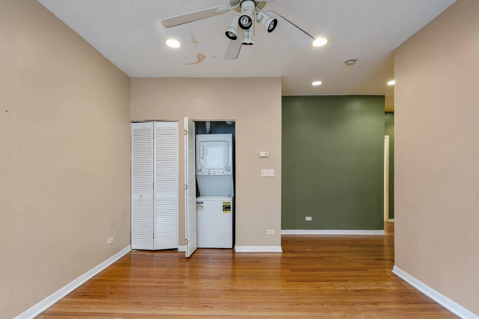 8154 South Drexel Avenue, Unit 2E Chicago, IL 60619 - Photo 4 of 15 an empty room with wooden floor and entrance
