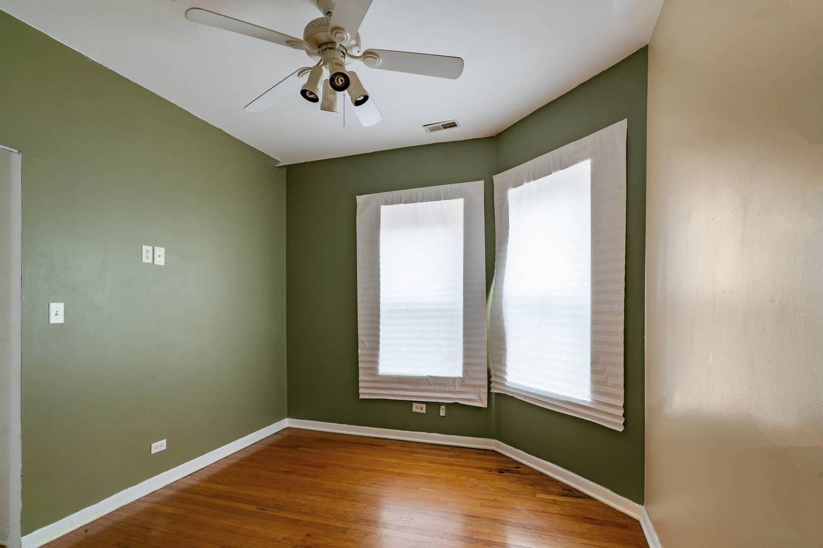 8154 South Drexel Avenue, Unit 2E Chicago, IL 60619 - Photo 8 of 15 an empty room with windows and fan