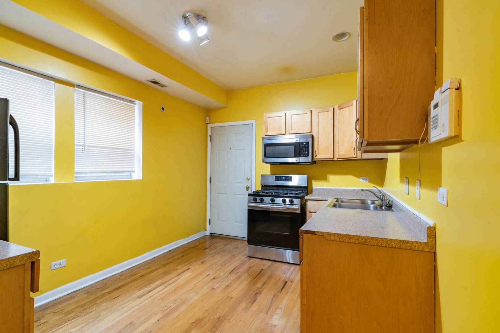 8154 South Drexel Avenue, Unit 2E Chicago, IL 60619 - Photo 10 of 15 a kitchen with a sink a stove top oven a counter top space and cabinets