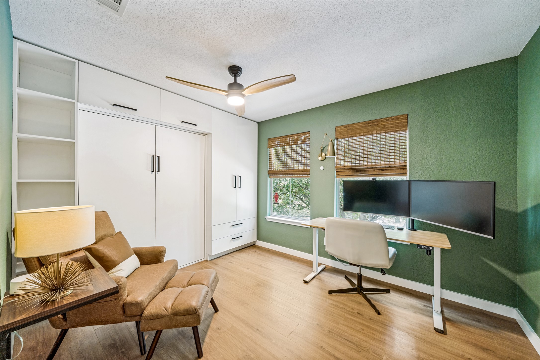 9205 Rowlands Sayle Road Austin, TX 78744 - Photo 11 of 25 A versatile room designed for productivity and relaxation, featuring built-in storage and sun-filled windows.