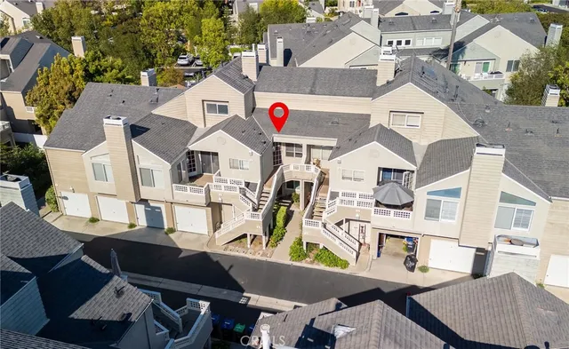 a view of a white house with wooden floor and fence