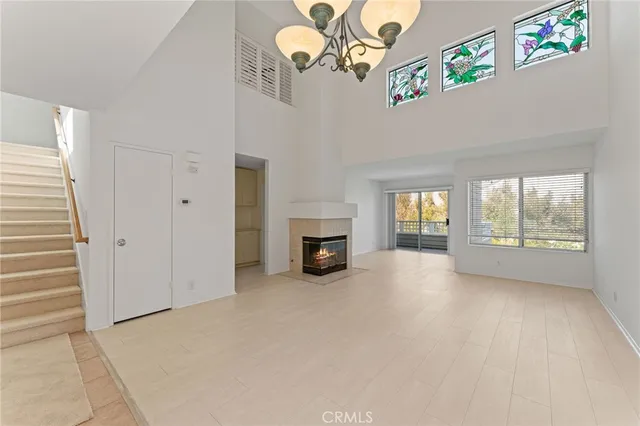 a view of a livingroom with an empty space and a fireplace