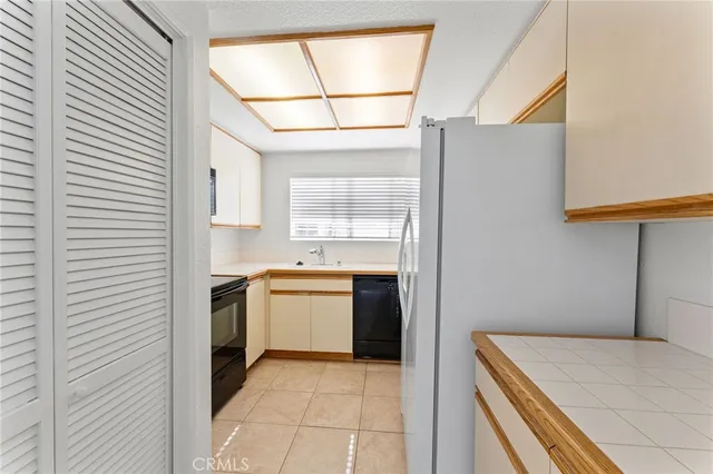 a kitchen with a refrigerator and a stove