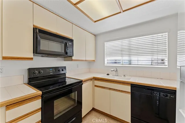 a kitchen with stainless steel appliances a stove sink microwave and cabinets