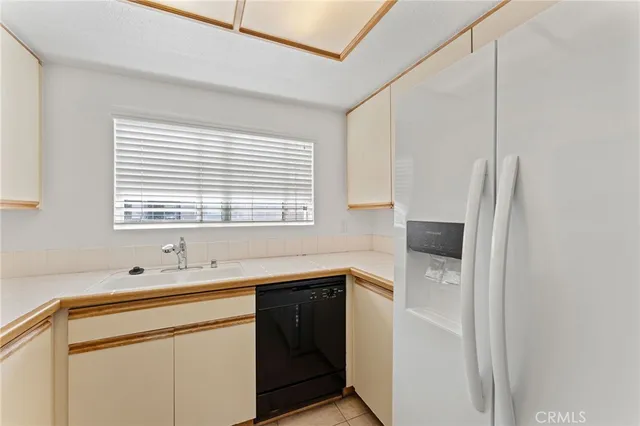a kitchen with a sink cabinets and window
