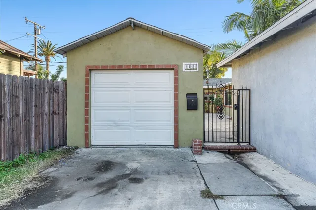 a view of a house with wooden fence