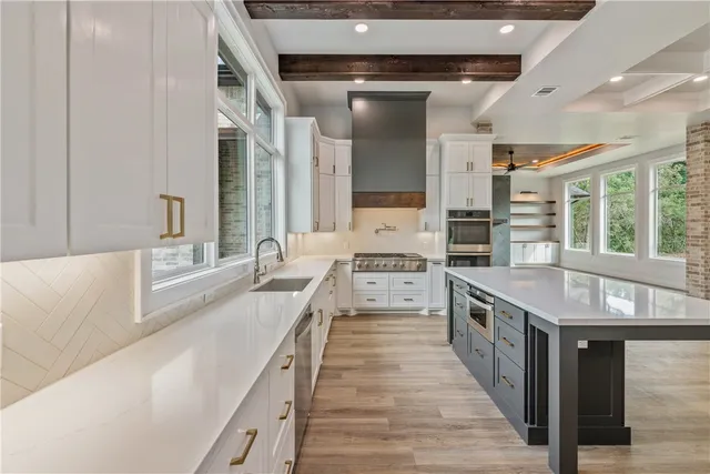 a kitchen with stainless steel appliances granite countertop a sink and cabinets