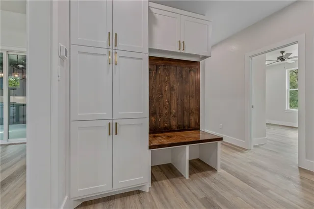 a kitchen with white cabinets and white appliances