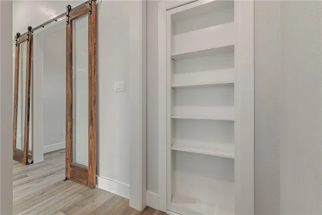 a bathroom with a shower and a door