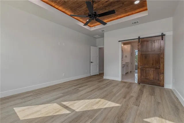a spacious bathroom with a double vanity sink mirror and bathtub
