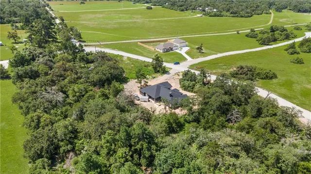 a view of a tennis ground with a small park