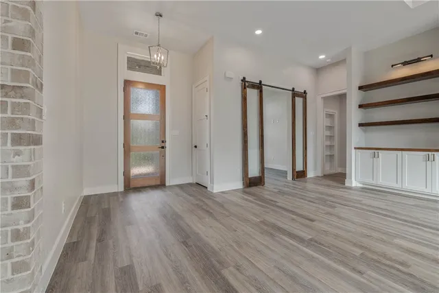 a view of an empty room with a window and fireplace