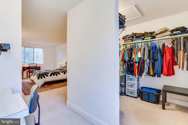 a bedroom with a bed and a lamp on table