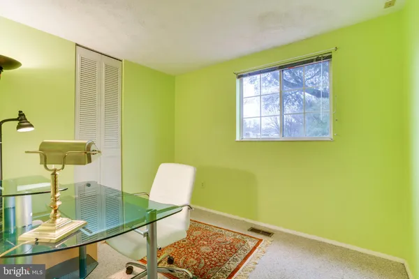 a white toilet sitting next to a bathroom sink and a mirror