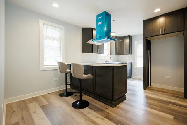 a kitchen with stainless steel appliances granite countertop a sink and a refrigerator