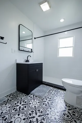 a bathroom with a toilet and a shower