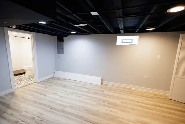 a view of empty room with wooden floor