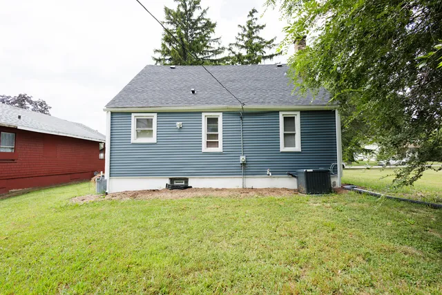 a house that has a big yard with wooden fence