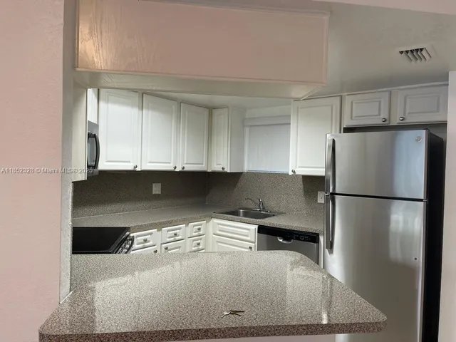 a kitchen with a refrigerator and a stove