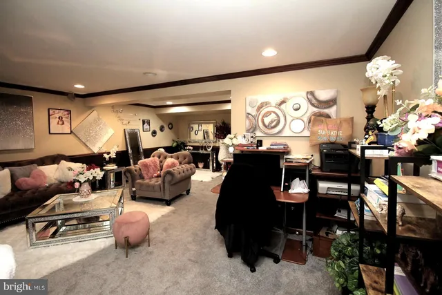 a living room with furniture a chandelier and a large mirror