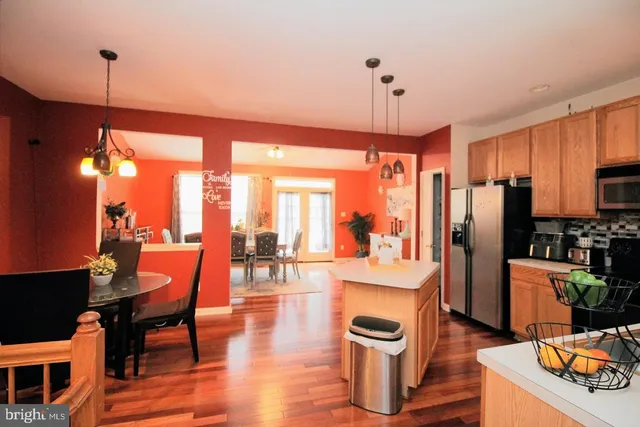 a dining room with furniture a chandelier and wooden floor