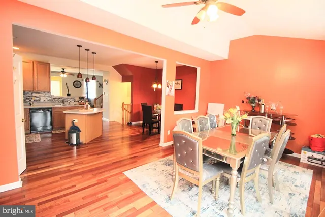 a living room with fireplace furniture and a wooden floor