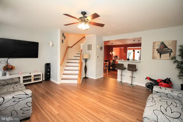 a bedroom with furniture and a wooden floor