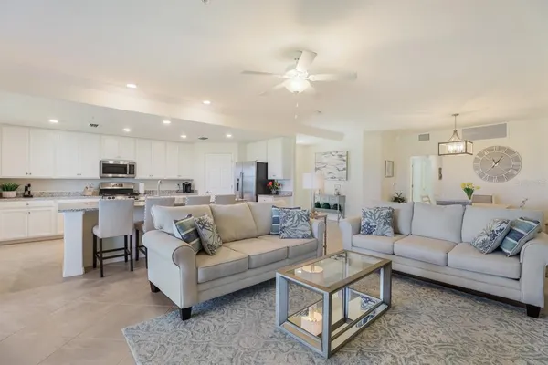 a living room with furniture and kitchen view