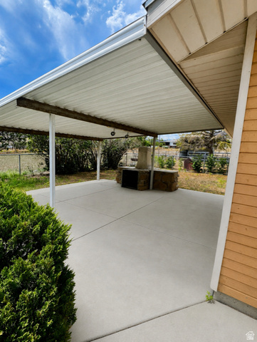 1766 Kenilworth Road Spring Glen, UT 84526 - Photo 13 of 24 Expansive covered patio featuring a concrete surface, built-in stone grill, and overhead lighting fixtures