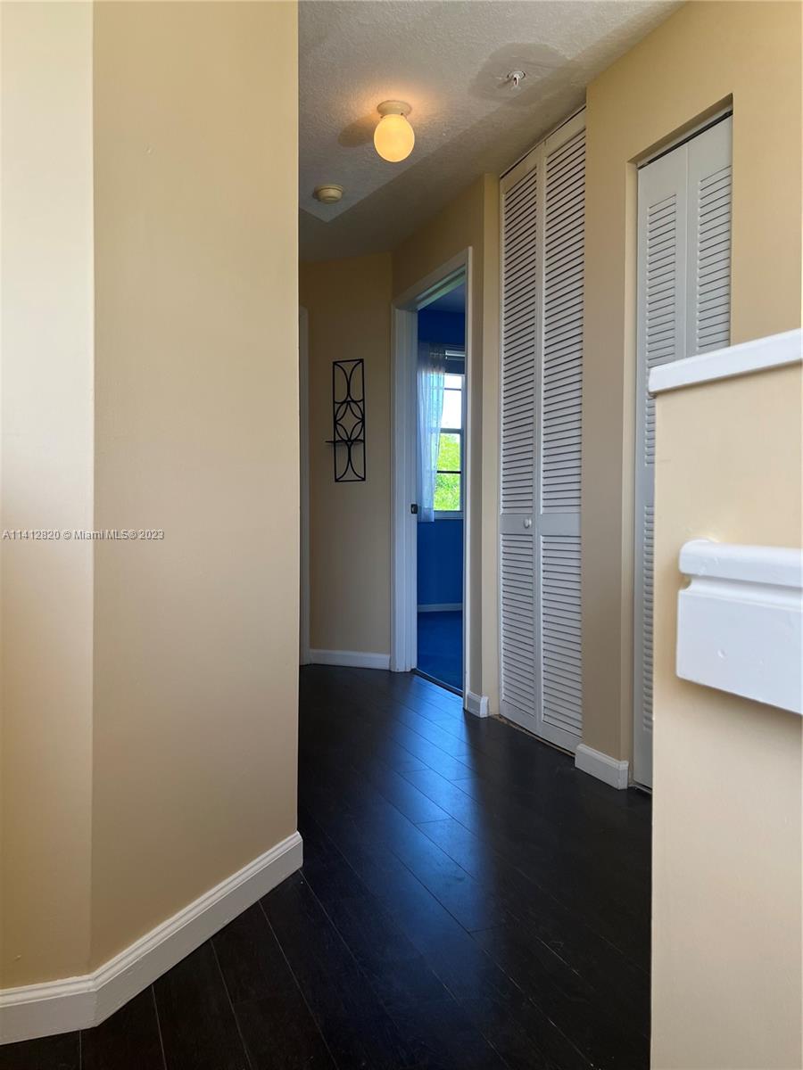 4812 Central Boulevard, Unit 20 Jupiter, FL 33458 - Photo 12 of 24 an empty room with wooden floor and windows