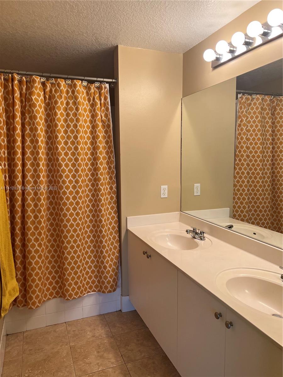 4812 Central Boulevard, Unit 20 Jupiter, FL 33458 - Photo 15 of 24 a bathroom with a granite countertop sink and a shower