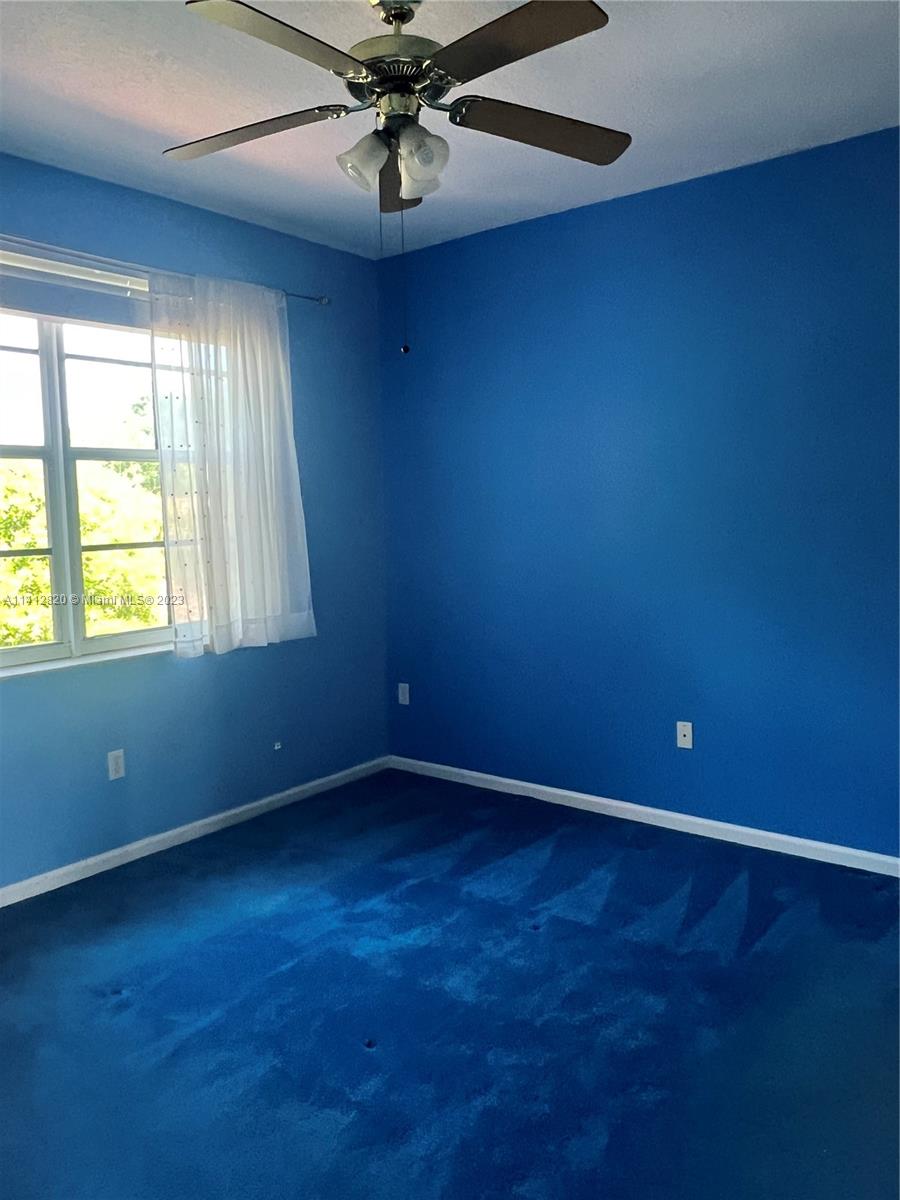 4812 Central Boulevard, Unit 20 Jupiter, FL 33458 - Photo 17 of 24 an empty room with a window and a fan