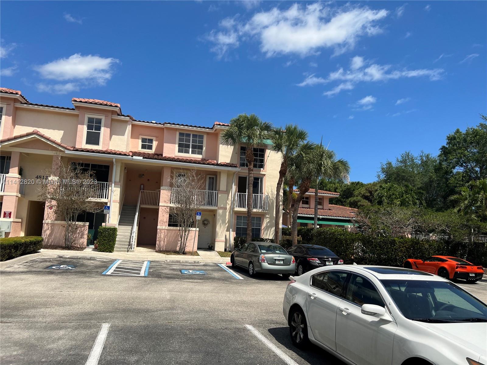 4812 Central Boulevard, Unit 20 Jupiter, FL 33458 - Photo 2 of 24 a view of a street that has couple of cars parked on the road