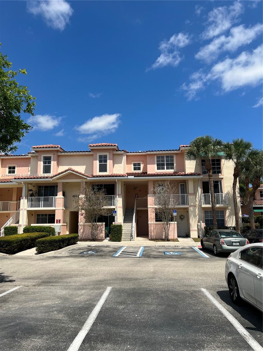 4812 Central Boulevard, Unit 20 Jupiter, FL 33458 - Photo 3 of 24 a front view of a house with a road