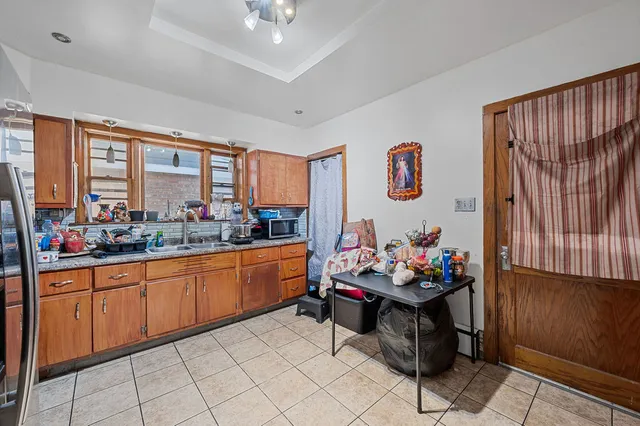 a kitchen with stainless steel appliances kitchen island granite countertop a sink and cabinets