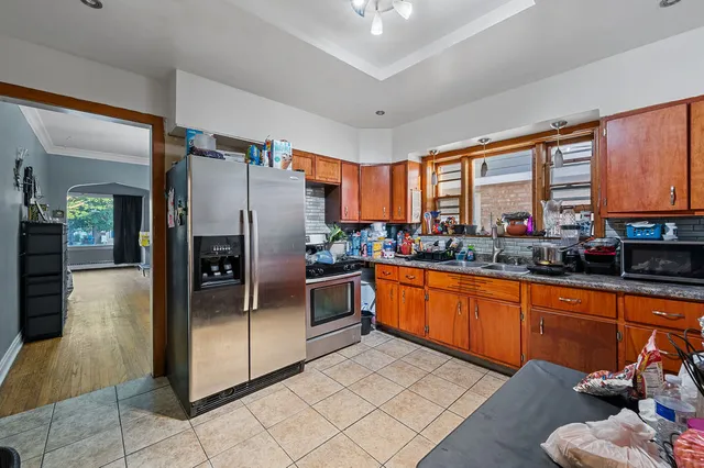 a kitchen with stainless steel appliances granite countertop a refrigerator and a sink