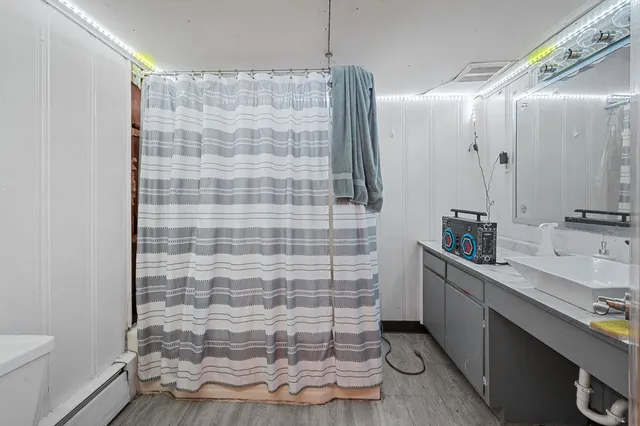 a bathroom with a double vanity sink toilet and shower