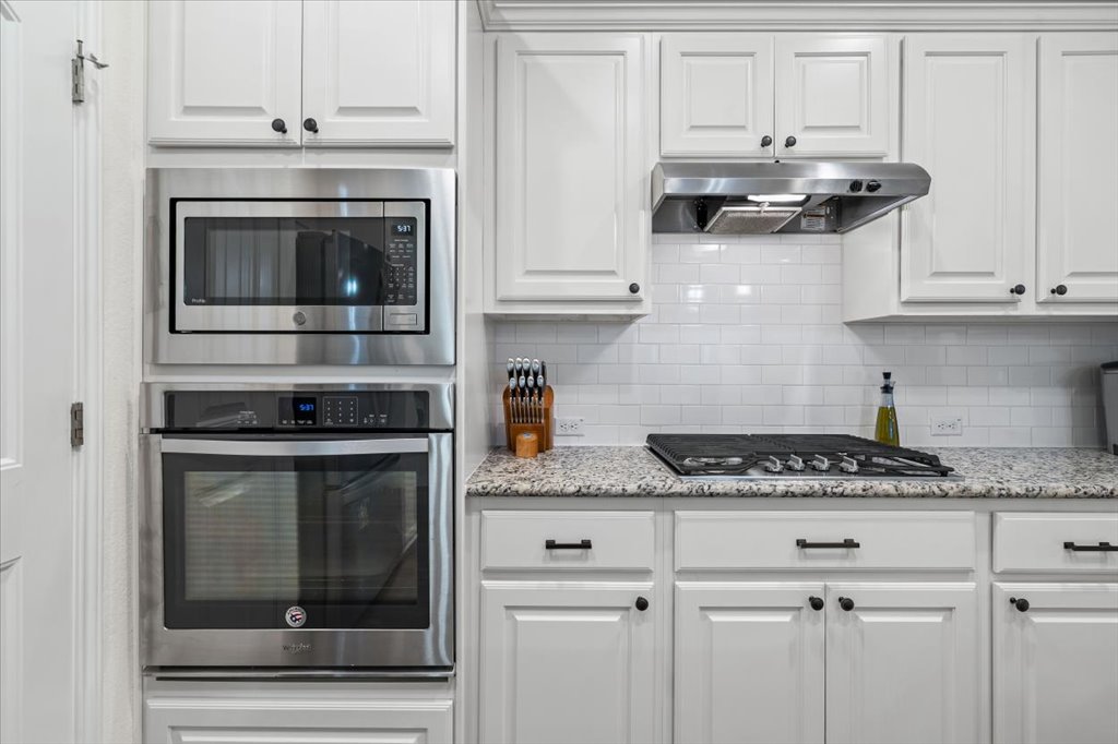 5912 Corrine Lane Austin, TX 78747 - Photo 7 of 27 Gourmet Style Kitchen with stainless steel appliances, white cabinets, and a natural gas cook top