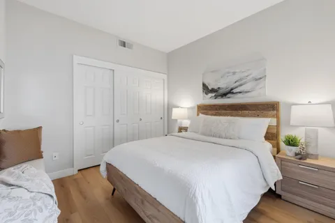 a bedroom with a bed and lamps