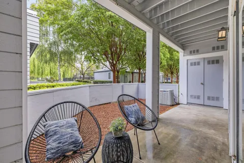 a view of a balcony with furniture and a shower