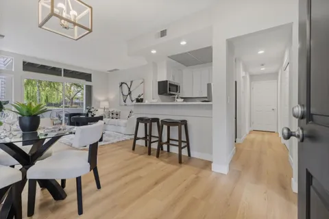 a view of a dining room with furniture and a kitchen
