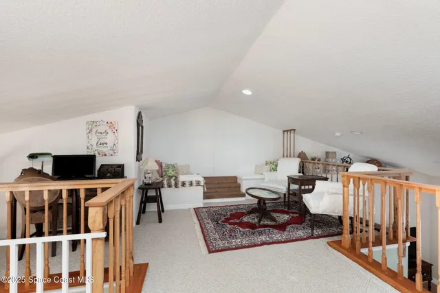 a view of a hallway with seating area