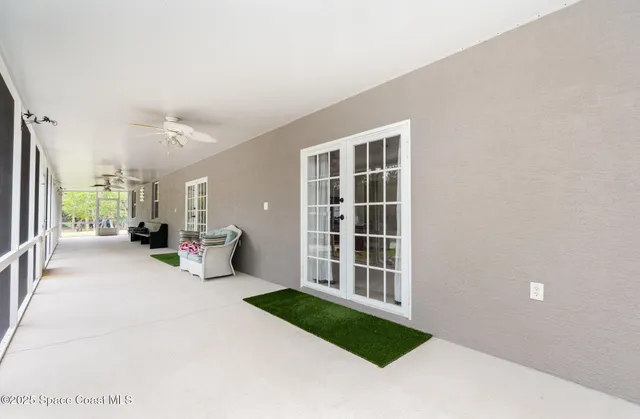 a view of a house with a patio and a yard