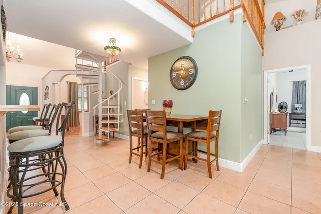 a dining room with a wooden table and chairs