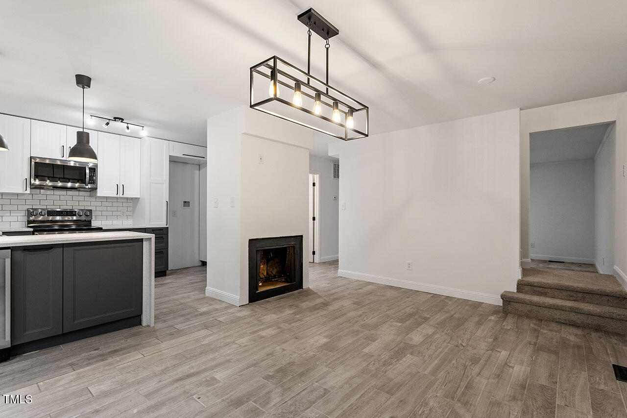 1016 North Bend Drive Raleigh, NC 27609 - Photo 16 of 36 a view of kitchen with sink microwave and stove top oven