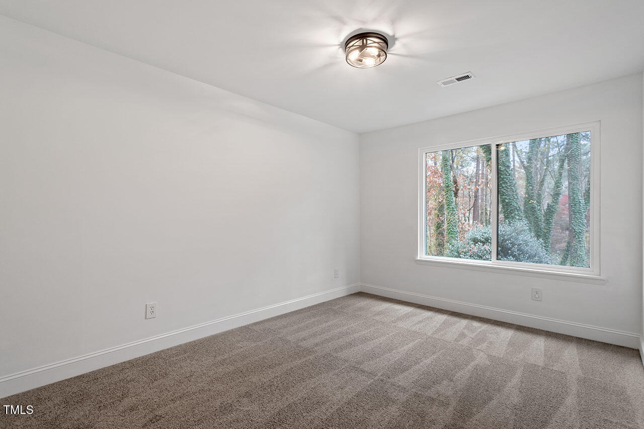 1016 North Bend Drive Raleigh, NC 27609 - Photo 22 of 36 an empty room with a window